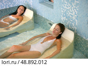 two women taking a special bath in a spa center. Стоковое фото, агентство Ingram Publishing / Фотобанк Лори