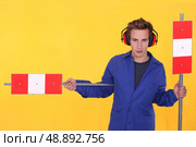 Man in ear defenders with warning signs. Стоковое фото, агентство Ingram Publishing / Фотобанк Лори