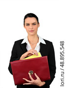 Smart woman taking a file out of a red briefcase. Стоковое фото, агентство Ingram Publishing / Фотобанк Лори