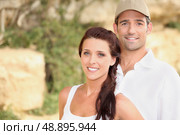 Couple stood outdoors by rocks. Стоковое фото, агентство Ingram Publishing / Фотобанк Лори