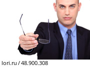 A businessman handing his glasses over. Стоковое фото, агентство Ingram Publishing / Фотобанк Лори