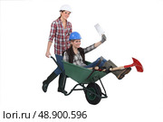 Female builders with a wheelbarrow. Стоковое фото, агентство Ingram Publishing / Фотобанк Лори
