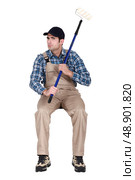 painter sulking and holding a roller. Стоковое фото, агентство Ingram Publishing / Фотобанк Лори