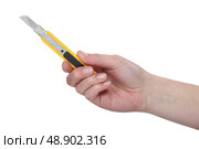 Hand holding a utility blade. Стоковое фото, агентство Ingram Publishing / Фотобанк Лори