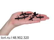 Hand holding tile spacers. Стоковое фото, агентство Ingram Publishing / Фотобанк Лори