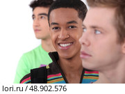 Young man surrounded by his peers. Стоковое фото, агентство Ingram Publishing / Фотобанк Лори