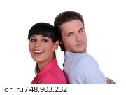 Couple stood back to back. Стоковое фото, агентство Ingram Publishing / Фотобанк Лори