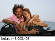 Couple relaxing in convertible sports car. Стоковое фото, агентство Ingram Publishing / Фотобанк Лори
