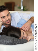 Man caressing his sleeping wife. Стоковое фото, агентство Ingram Publishing / Фотобанк Лори