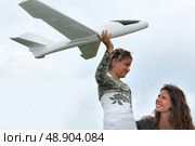 little girl playing with a small scale model of plane. Стоковое фото, агентство Ingram Publishing / Фотобанк Лори