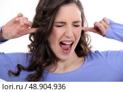 Woman with her fingers in her ears. Стоковое фото, агентство Ingram Publishing / Фотобанк Лори