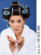 Woman with her hair in rollers blowing a kiss. Стоковое фото, агентство Ingram Publishing / Фотобанк Лори