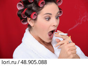 Woman with curlers and lit cigarette. Стоковое фото, агентство Ingram Publishing / Фотобанк Лори