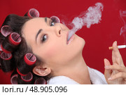 woman with curlers in her hair smoking. Стоковое фото, агентство Ingram Publishing / Фотобанк Лори