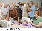 Elderly men and women spending time sewing in workroom. Стоковое фото, фотограф Яков Филимонов / Фотобанк Лори