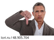 Thumbs down from a disapproving man. Стоковое фото, агентство Ingram Publishing / Фотобанк Лори