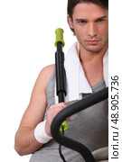 Man with a chest expander. Стоковое фото, агентство Ingram Publishing / Фотобанк Лори