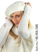 pretty coquettish young blonde wearing white cardigan and bonnet. Стоковое фото, агентство Ingram Publishing / Фотобанк Лори
