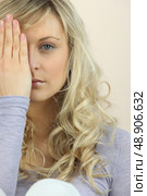 Girl hiding one eye behind her hand. Стоковое фото, агентство Ingram Publishing / Фотобанк Лори