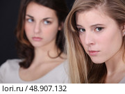 Two young women post-argument. Стоковое фото, агентство Ingram Publishing / Фотобанк Лори