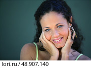 Timid brunette holding her hands to her face. Стоковое фото, агентство Ingram Publishing / Фотобанк Лори