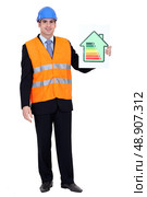Engineer holding up efficiency chart. Стоковое фото, агентство Ingram Publishing / Фотобанк Лори