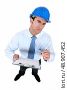 An architect with a weird facial expression. Стоковое фото, агентство Ingram Publishing / Фотобанк Лори