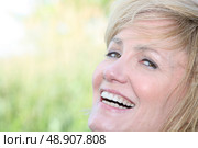 Facial closeup of a smiling woman with a wide grin. Стоковое фото, агентство Ingram Publishing / Фотобанк Лори