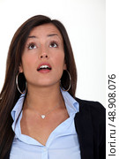 A surprised woman looking up at something. Стоковое фото, агентство Ingram Publishing / Фотобанк Лори
