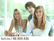 Three classmates revising together. Стоковое фото, агентство Ingram Publishing / Фотобанк Лори