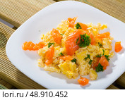 Cooked tasty omlette fried with salmon served at plate on table. Стоковое фото, фотограф Яков Филимонов / Фотобанк Лори