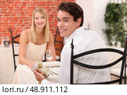 Couple in restaurant with present. Стоковое фото, агентство Ingram Publishing / Фотобанк Лори