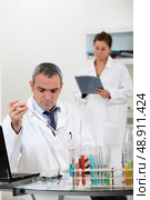a scientist using test tubes. Стоковое фото, агентство Ingram Publishing / Фотобанк Лори