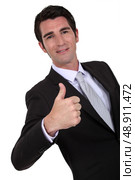 Businessman giving thumbs up gesture. Стоковое фото, агентство Ingram Publishing / Фотобанк Лори