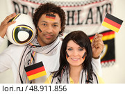 Couple supporting the German football team. Стоковое фото, агентство Ingram Publishing / Фотобанк Лори