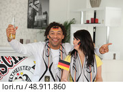 German couple celebrating win. Стоковое фото, агентство Ingram Publishing / Фотобанк Лори