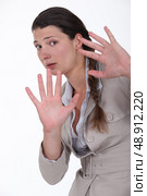 woman looking scared with hands stretched forward. Стоковое фото, агентство Ingram Publishing / Фотобанк Лори