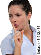 Serious brunette shushing. Стоковое фото, агентство Ingram Publishing / Фотобанк Лори