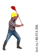 Workman brandishing a shovel on white background. Стоковое фото, агентство Ingram Publishing / Фотобанк Лори