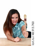 Woman holding a paintbrush. Стоковое фото, агентство Ingram Publishing / Фотобанк Лори