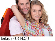 Cuddle with shopping bags. Стоковое фото, агентство Ingram Publishing / Фотобанк Лори