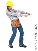 Female construction worker pointing with both hands. Стоковое фото, агентство Ingram Publishing / Фотобанк Лори