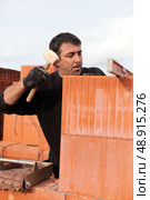 Man hitting wall with mallet. Стоковое фото, агентство Ingram Publishing / Фотобанк Лори