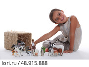 Little girl playing with farm animal toys. Стоковое фото, агентство Ingram Publishing / Фотобанк Лори