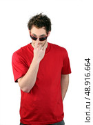 Man pushing his sunglasses up his nose. Стоковое фото, агентство Ingram Publishing / Фотобанк Лори