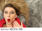 Woman laying on carpet. Стоковое фото, агентство Ingram Publishing / Фотобанк Лори