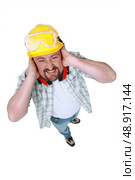 Landscape picture of worker covering his ears. Стоковое фото, агентство Ingram Publishing / Фотобанк Лори