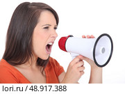 Angry woman screaming in speakerphone. Стоковое фото, агентство Ingram Publishing / Фотобанк Лори