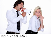 Man shouting at colleague through megaphone. Стоковое фото, агентство Ingram Publishing / Фотобанк Лори