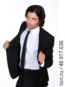 Man opening his suit jacket. Стоковое фото, агентство Ingram Publishing / Фотобанк Лори